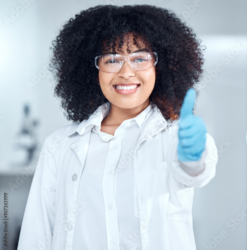 Woman, scientist and happy with thumbs up in lab for science research, experiment and investigation. Female person, portrait and confident with smile for medical or medicine study and agreement
