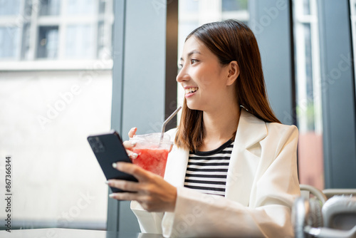 Young asian smiling woman with soft drink sitting in the coffee shop cafe. Business woman laughing talking with friend inside restaurant. People lifestyle concept. Free Download Young asian smiling woman with soft drink sitting in the coffee shop cafe. Business woman laughing talking with friend inside restaurant. People lifestyle concept. - GFXLoad