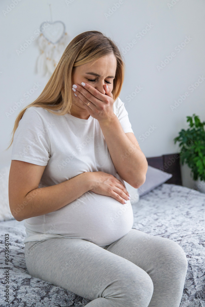 A pregnant woman is sick of toxicosis. Selective focus. A pregnant woman is sick of toxicosis. Selective focus.