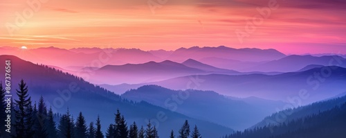 Stunning mountain landscape with majestic peaks shrouded in fog and a colorful sky reflecting in the morning mist. Creating a breathtaking blend of colors