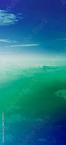 A serene aerial gradient of blues and greens depicting a tranquil and peaceful sky transitioning into earth