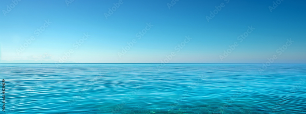 Obraz premium ocean horizon over calm clear blue sea water with cloudy blue sky