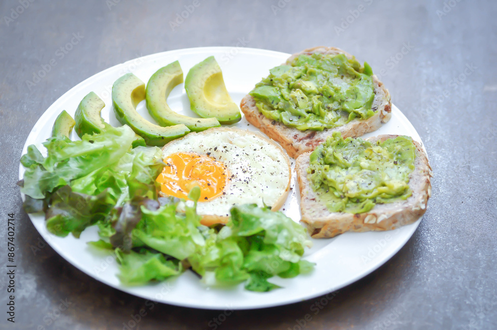 bread with mashed avocado topping ,sunny side up egg with lettuce and avocado bread with mashed avocado topping ,sunny side up egg with lettuce and avocado