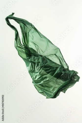 A single green plastic bag suspended in mid-air, with no visible attachment points