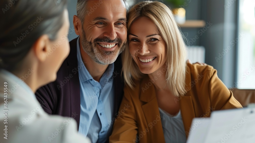 Smiling Couple Meeting Financial Planner to Discuss Investments Smiling Couple Meeting Financial Planner to Discuss Investments