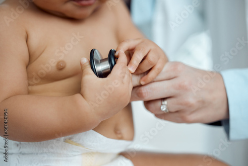 Stethoscope, hands of baby and doctor in clinic for check up, healthcare and progress for growth. Child, pediatrician and touching equipment for post natal assessment, development and cardiology