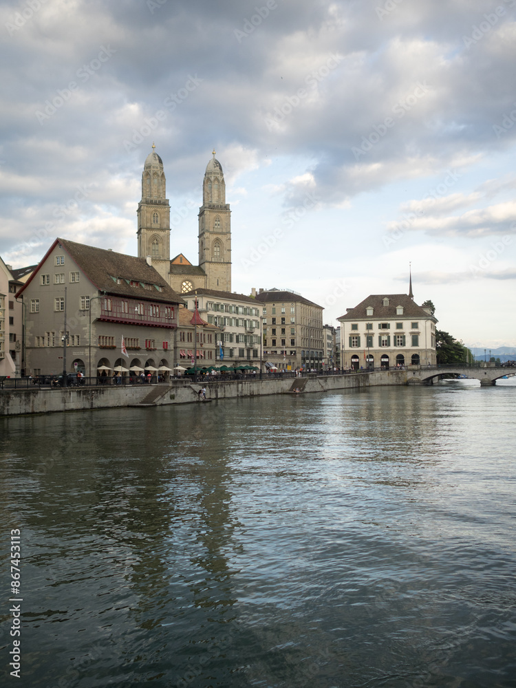 Obraz premium Grossmunster towers over Zurich riverside buildings