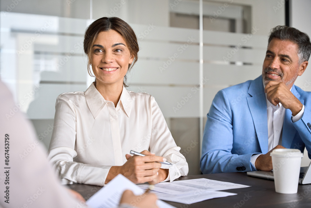 Smiling female manager working with colleagues in office, consulting client or investor, conducting job interview. Happy busy business people corporate executive team talking at group meeting. Smiling female manager working with colleagues in office, consulting client or investor, conducting job interview. Happy busy business people corporate executive team talking at group meeting.
