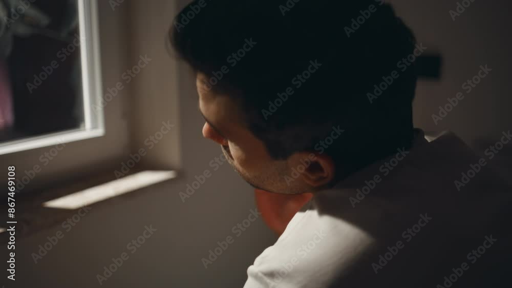 Sleepless man looking window with pensive mood closeup. Tired guy sitting bed Sleepless man looking window with pensive mood closeup. Tired guy sitting bed