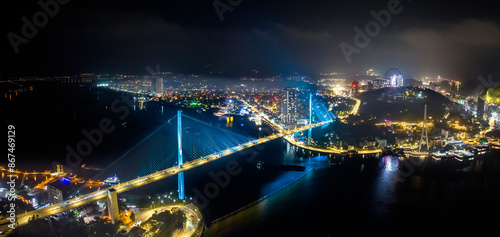 Aerial view of Bai Chay bridge night lights shimmering two peninsula connected Hon Gai and Bai Chay in Ha Long city, Quang Ninh province, Vietnam photo