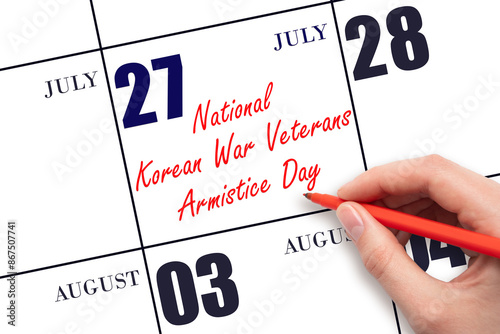 July 27. Hand writing text National Korean War Veterans Armistice Day on calendar date. Save the date. photo