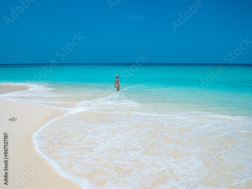 Serene tropical getaway woman relaxing in clear blue waters