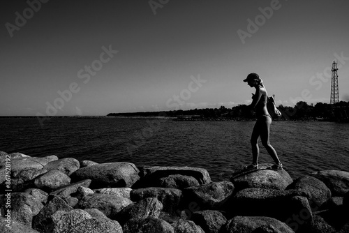 silhouette of a person on the stone beach