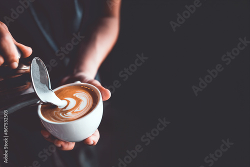 vintage tone of barista pour milk to making latte art coffee at cafe or coffe shop