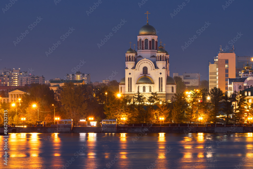 The city of Yekaterinburg, Sverdlovsk region, Russia. View from the Iset river to the Church of All Saints. Evening cityscape with a beautiful large Orthodox church. The city of Yekaterinburg, Sverdlovsk region, Russia. View from the Iset river to the Church of All Saints. Evening cityscape with a beautiful large Orthodox church.