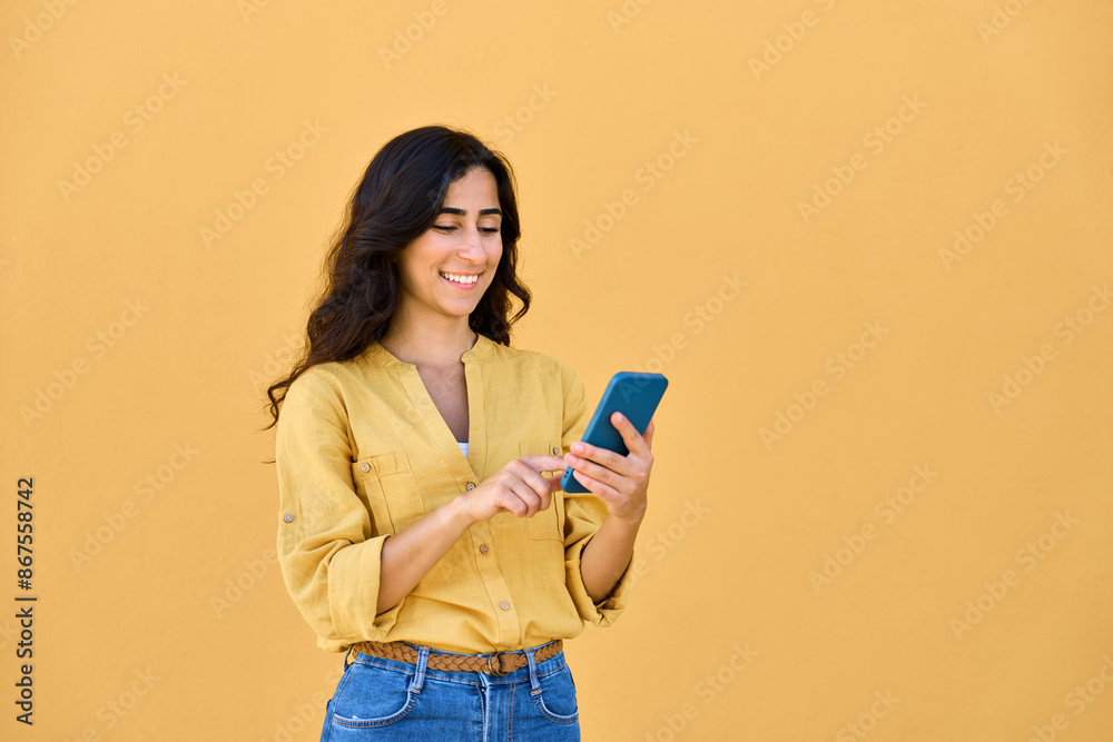 Young middle eastern brunette woman in casual clothes using mobile cellphone app for communication, shopping, buying, trading online. Smiling arabian girl holding smartphone phone, scrolling, typing Young middle eastern brunette woman in casual clothes using mobile cellphone app for communication, shopping, buying, trading online. Smiling arabian girl holding smartphone phone, scrolling, typing