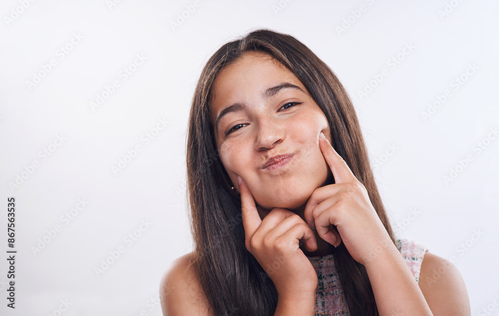 Girl, teenager and funny face with cheeks in studio portrait for joke, happy and fingers by white background. Person, model and smile with hands, dimples or comic emoji for humor with mockup space Girl, teenager and funny face with cheeks in studio portrait for joke, happy and fingers by white background. Person, model and smile with hands, dimples or comic emoji for humor with mockup space