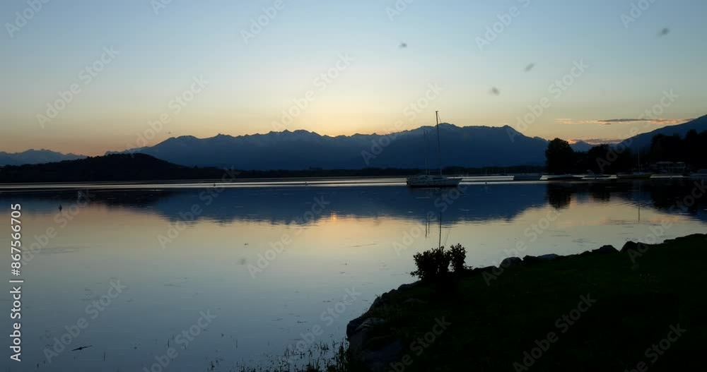 Beautiful sunset by the lake with silhouette mountain. Slow motion 4K Beautiful sunset by the lake with silhouette mountain. Slow motion 4K