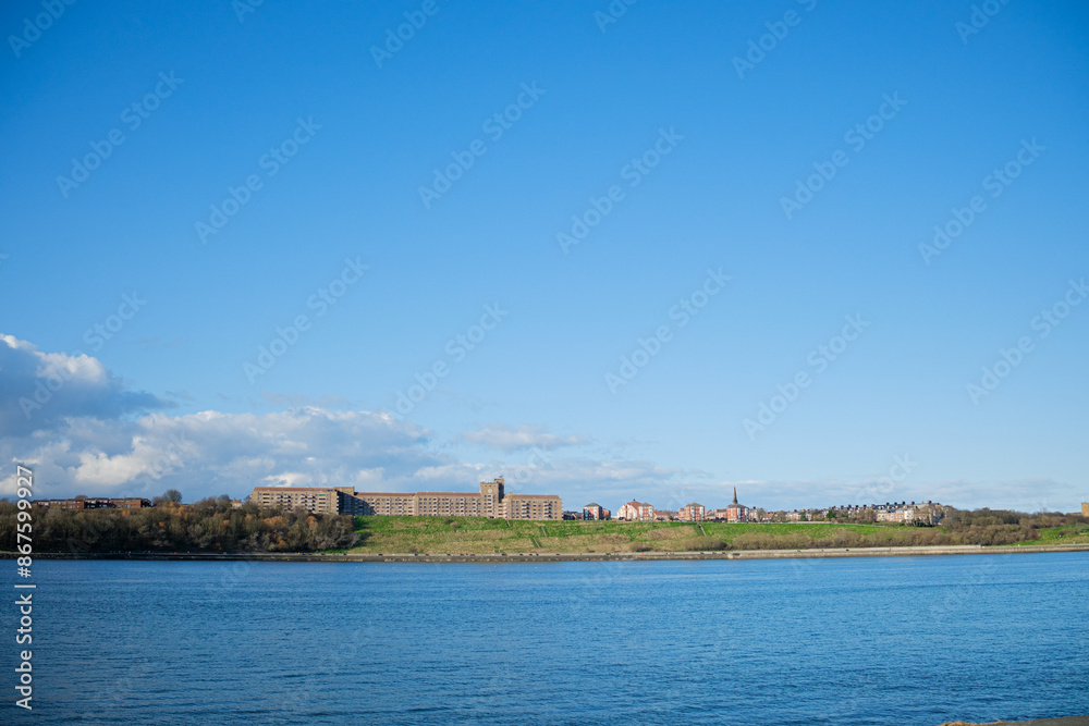 Fototapeta premium South Shields UK: 22nd Feb 2024:A view of the North Shields skyline across the River Tyne, taken from South Shields on a clear, sunny day.