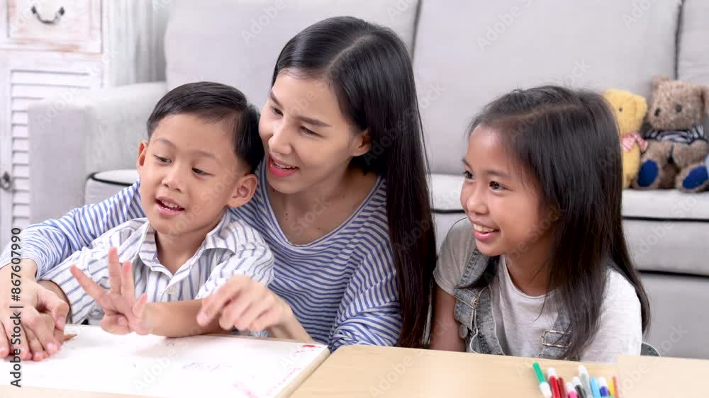 Multitasking mother teaching homework counting number reviewing basic math for cute sibling elementary school children, Asian mom woman take care kids enjoy playtime activity sitting on sofa together Multitasking mother teaching homework counting number reviewing basic math for cute sibling elementary school children, Asian mom woman take care kids enjoy playtime activity sitting on sofa together