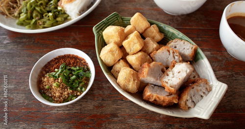 Deep fried tofu and fried taro, served with sweet chili sauce with ground roasted peanuts. Famous Chinese appitizer, Chinese cuisine. Vegetarian food.
