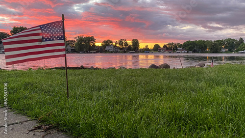 American Flag in the Yard with Pink Sunset over Yahara River Channel in Madison Wisconsin photo