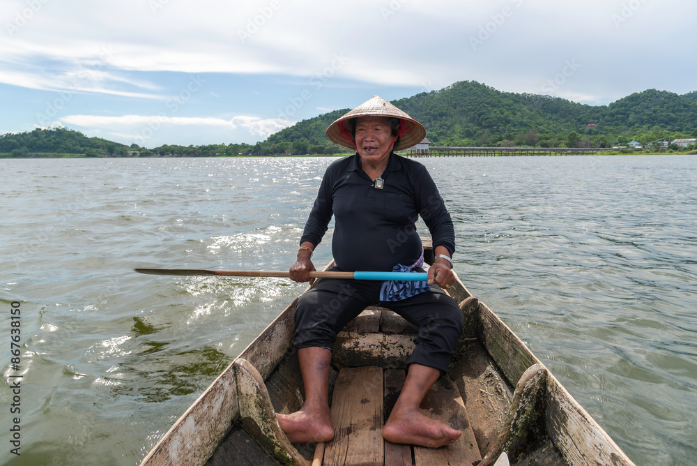 fisherman rowing boat on the river bank of summer fisherman rowing boat on the river bank of summer