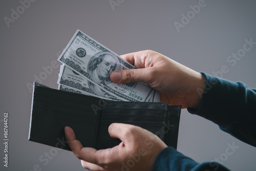 Photography Person holding US dollar bills and wallet