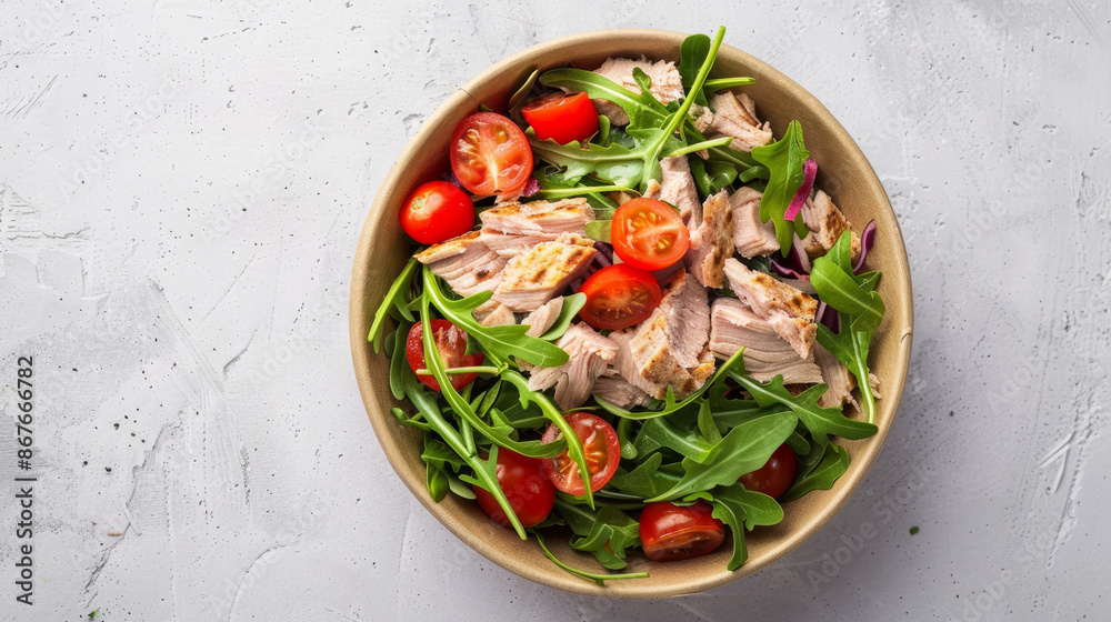 Salad with tuna, tomatoes, and arugula on a light background. This is a healthy vegetarian lunch option. It's delivered in a brown paper plate, which is eco-friendly. Salad with tuna, tomatoes, and arugula on a light background. This is a healthy vegetarian lunch option. It's delivered in a brown paper plate, which is eco-friendly.