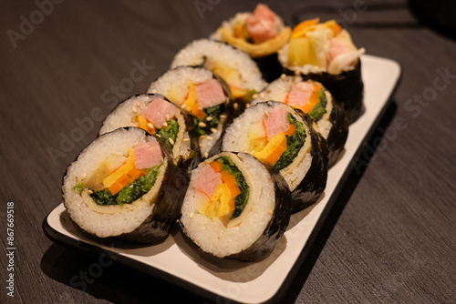 Kimbap is similar to Japanese sushi, but it has a few differences, such as the use of sesame oil in the rice and the inclusion of a wider variety of vegetables and meats.