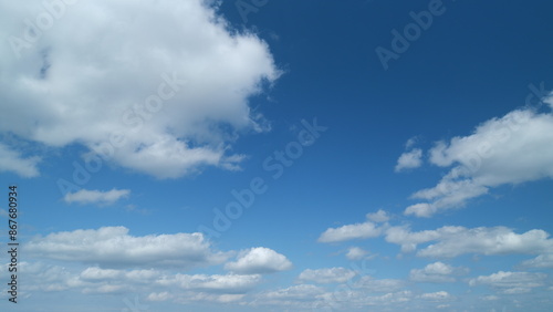 Beautiful cumulus and stratocumulus clouds in blue sky. Clear weather, sunny day. Beautiful white cumulus clouds. Timelapse.
