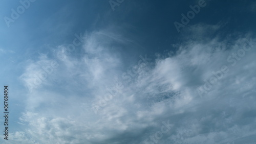 Soft white clouds moving on blue sky background. Tropical summer or spring sunlight. Daytime. Timelapse. © artifex.orlova