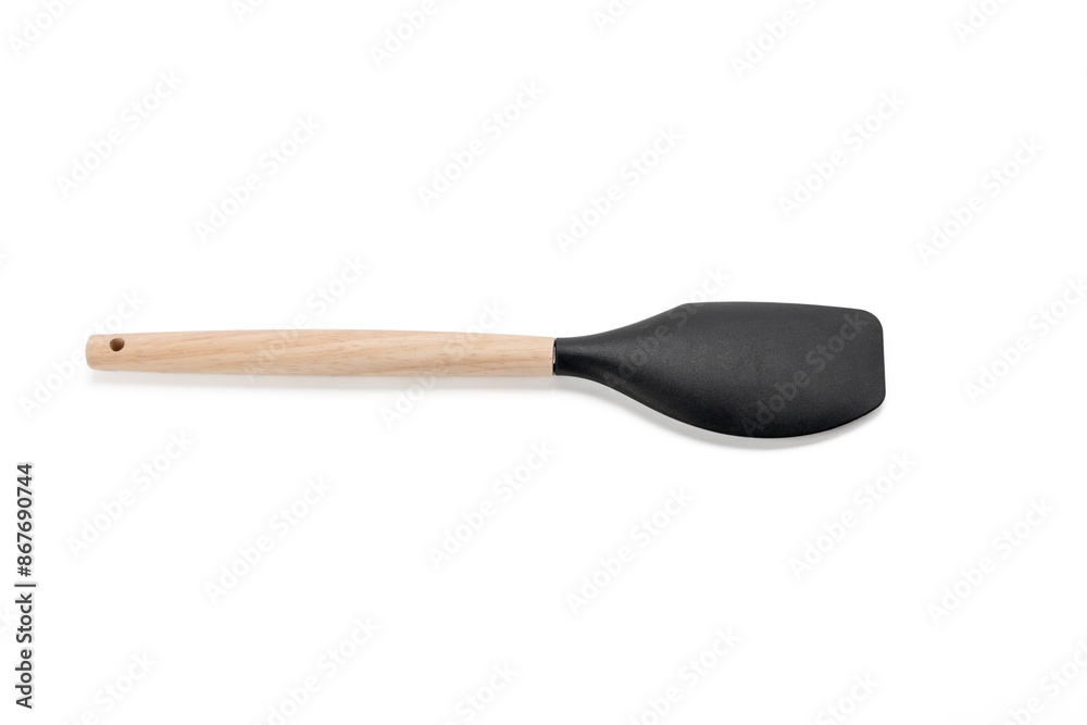 Black spatula with wooden handle. The spatula is long and thin. He sits on a white background Black spatula with wooden handle. The spatula is long and thin. He sits on a white background