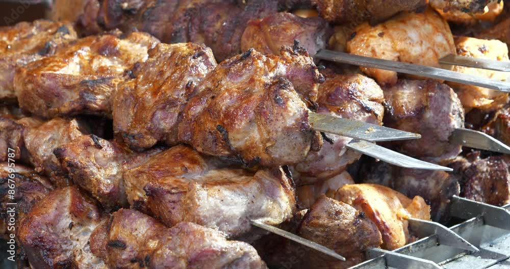 Grilled meat. Shish kebabs broils in barbecue. Meat are cooked on hot coals in chargrill. Many hot kebabs. Smoke from hot coals. Fat runs down the meat Grilled meat. Shish kebabs broils in barbecue. Meat are cooked on hot coals in chargrill. Many hot kebabs. Smoke from hot coals. Fat runs down the meat