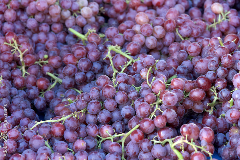 Close up on piles of fresh ripe purple grapes sale at farmers market.. View from above. Close up on piles of fresh ripe purple grapes sale at farmers market.. View from above.