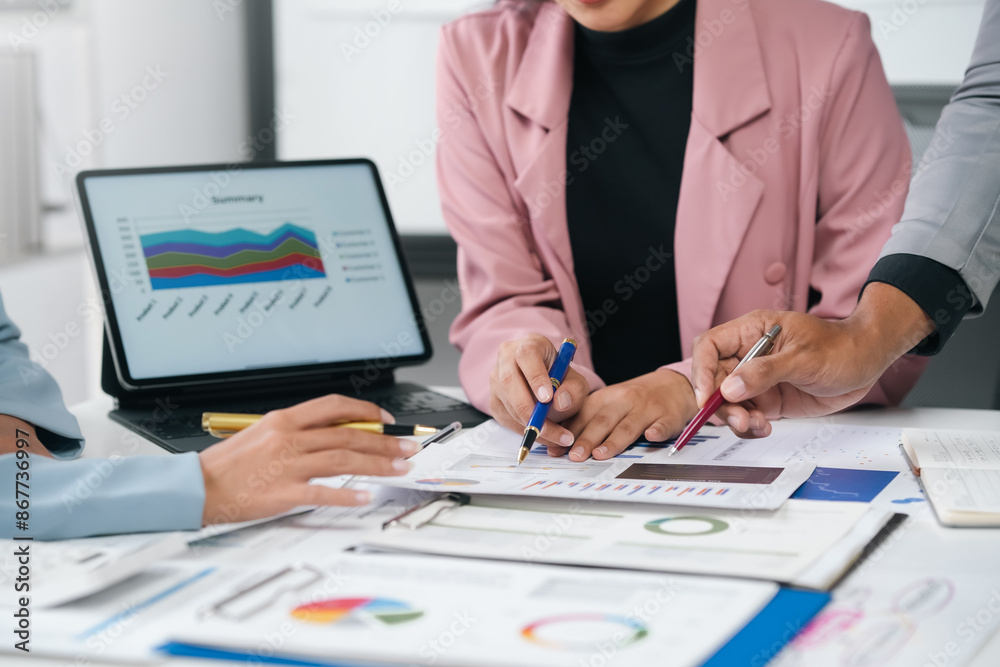 Business team analyzing financial data with charts and graphs Business team analyzing financial data with charts and graphs