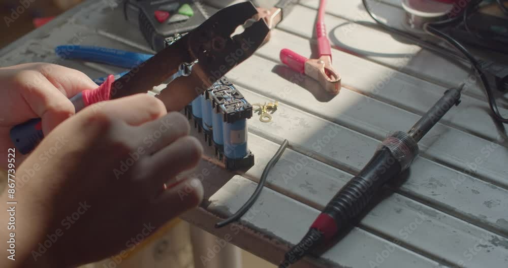 Strip the wires using a specialized tool.Master electrician removes