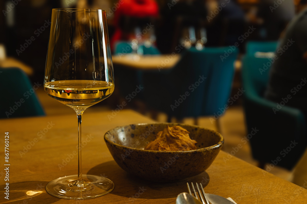 Fototapeta premium A glass of white wine at the bar. a glass of white wine in a restaurant, alcohol background