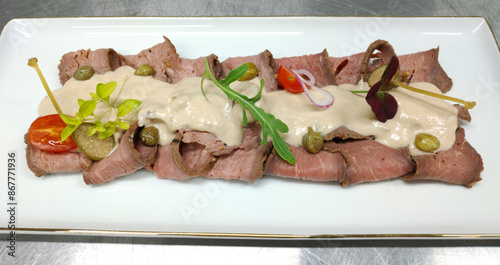 vitello tonnato is a dish of thinly sliced pieces of marinated veal, seasoned with a cream sauce, one of the ingredients of which is tuna. Is a cold dish or snack photo