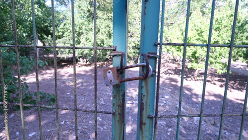 Close-up of padlock on garden gate.