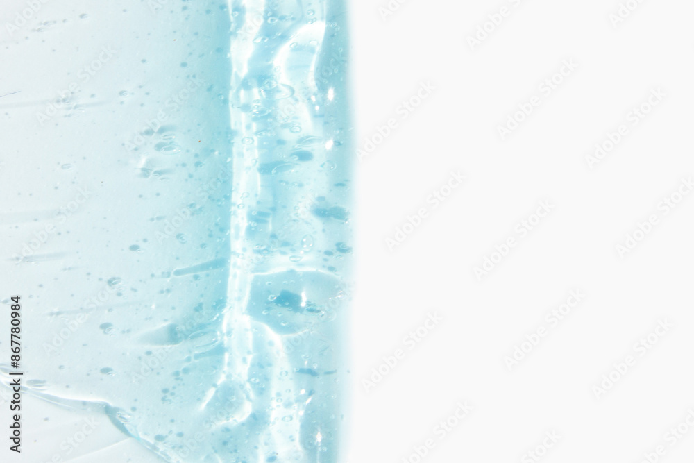 Smears of cosmetic texture of blue gel on a light background Smears of cosmetic texture of blue gel on a light background