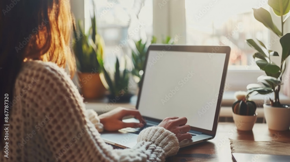 Domestic Digital Workspace: Women Working at Home with a Laptop and a Blank White Desktop Screen Domestic Digital Workspace: Women Working at Home with a Laptop and a Blank White Desktop Screen