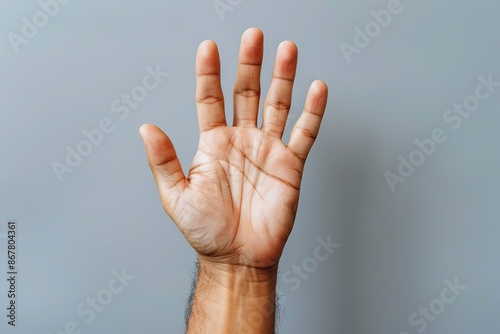 A man reaching out towards the camera on a gray background