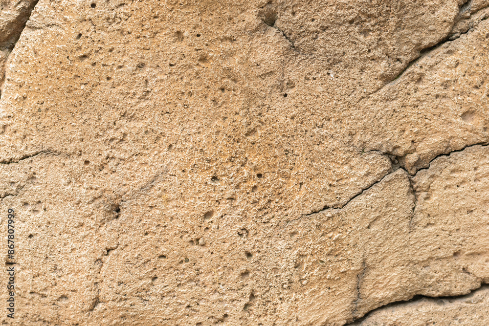 Detailed Close-Up of Beige Stone Texture with Natural Cracks and Rough Surface Detailed Close-Up of Beige Stone Texture with Natural Cracks and Rough Surface