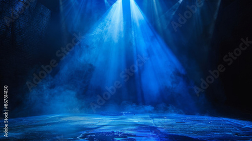 A spotlight of bright blue color lit up a dark stage, it made a beautiful contrast between light and dark. © Rabil