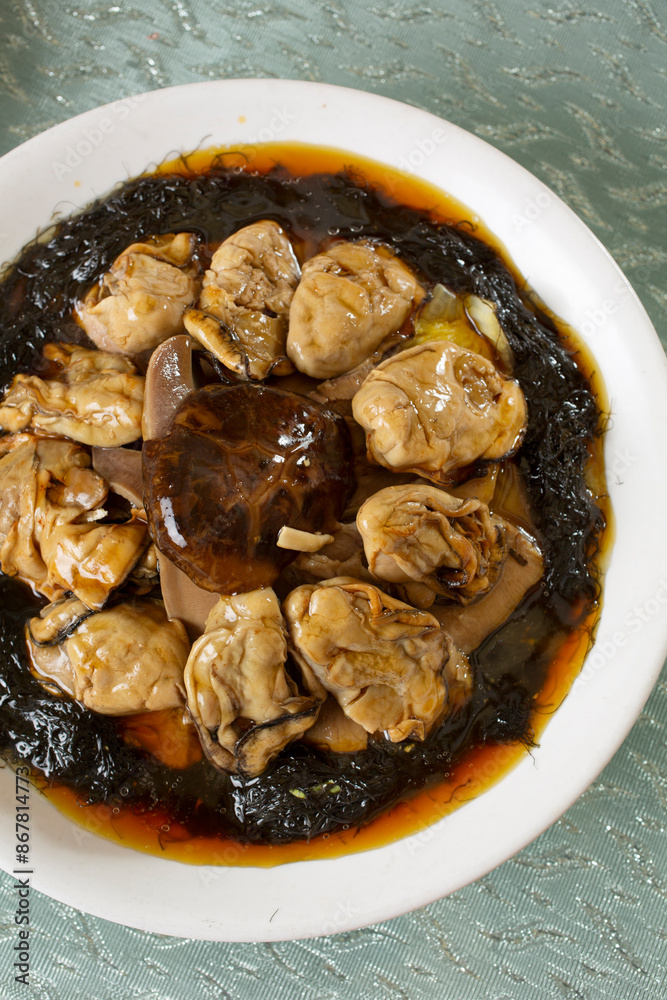 A top down view of a platter of braised oysters. A top down view of a platter of braised oysters.