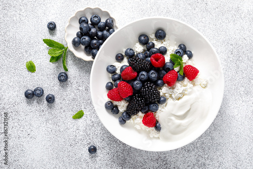 Cheese cottage with yogurt and fresh berries. Curd with blueberry, raspberry and blackberry, top view