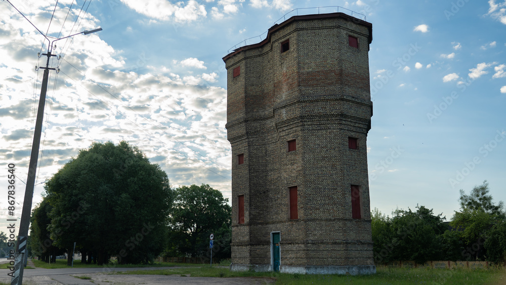 An old brick tower and a nearby power pole An old brick tower and a nearby power pole