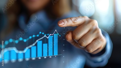 A woman is pointing at a graph on a screen