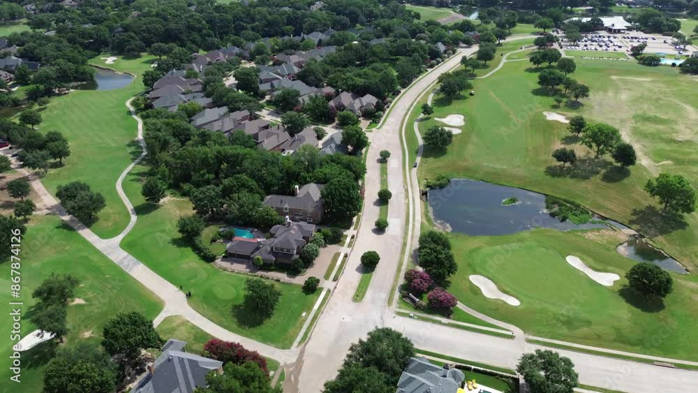 Flyover Columbine Way in golf course community urban sprawl row of upscale two-story large residential houses concrete tiles roof, swimming pool East of Plano, Texas, Dallas Fort Worth metroplex